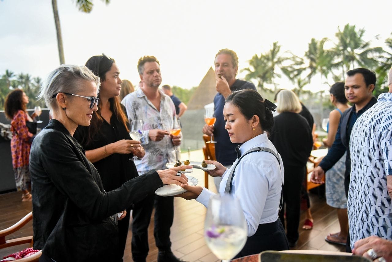 A Bali catering event with a waitress serving guests
