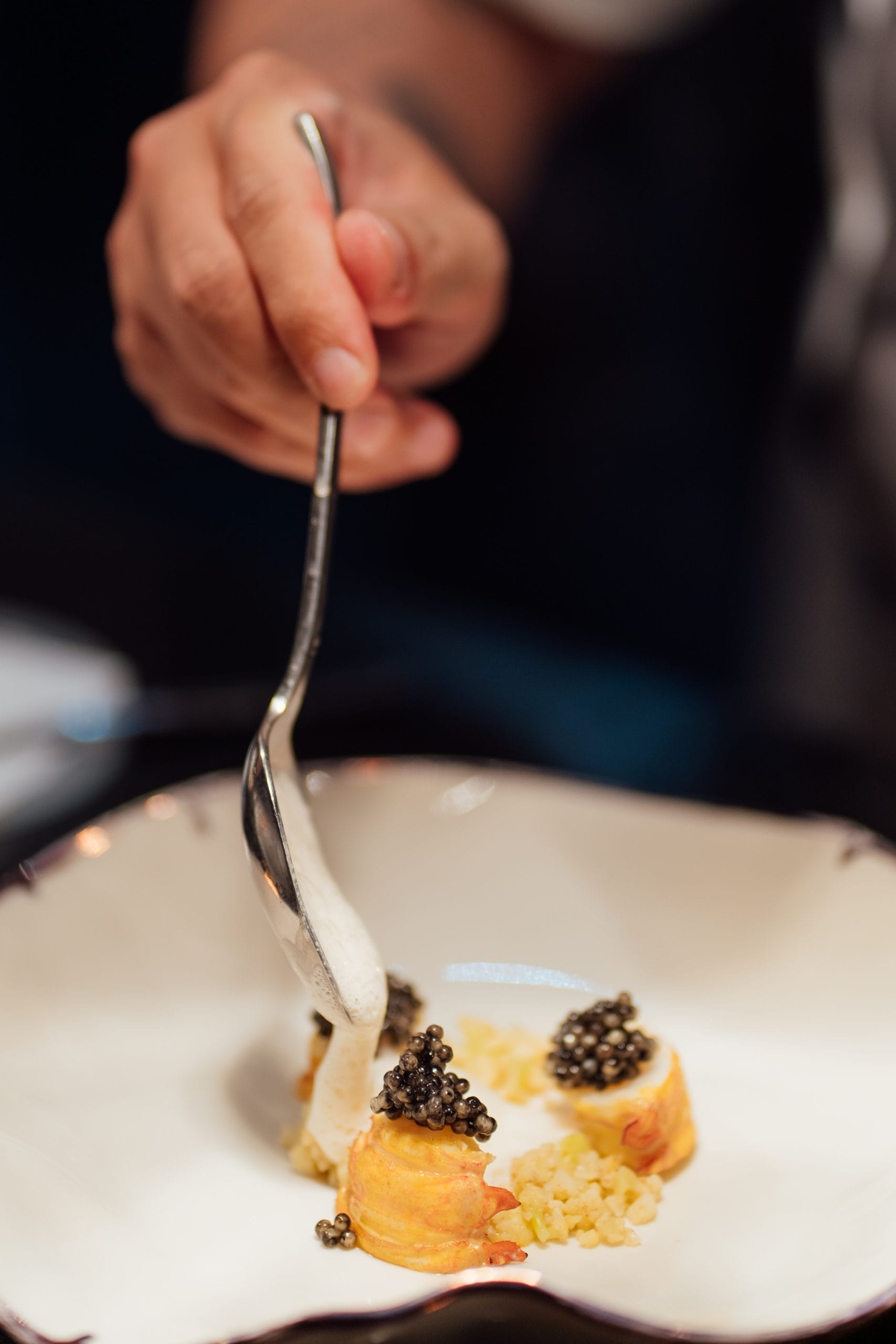 A catered dish of caviar on top of a blini at an event in Bali