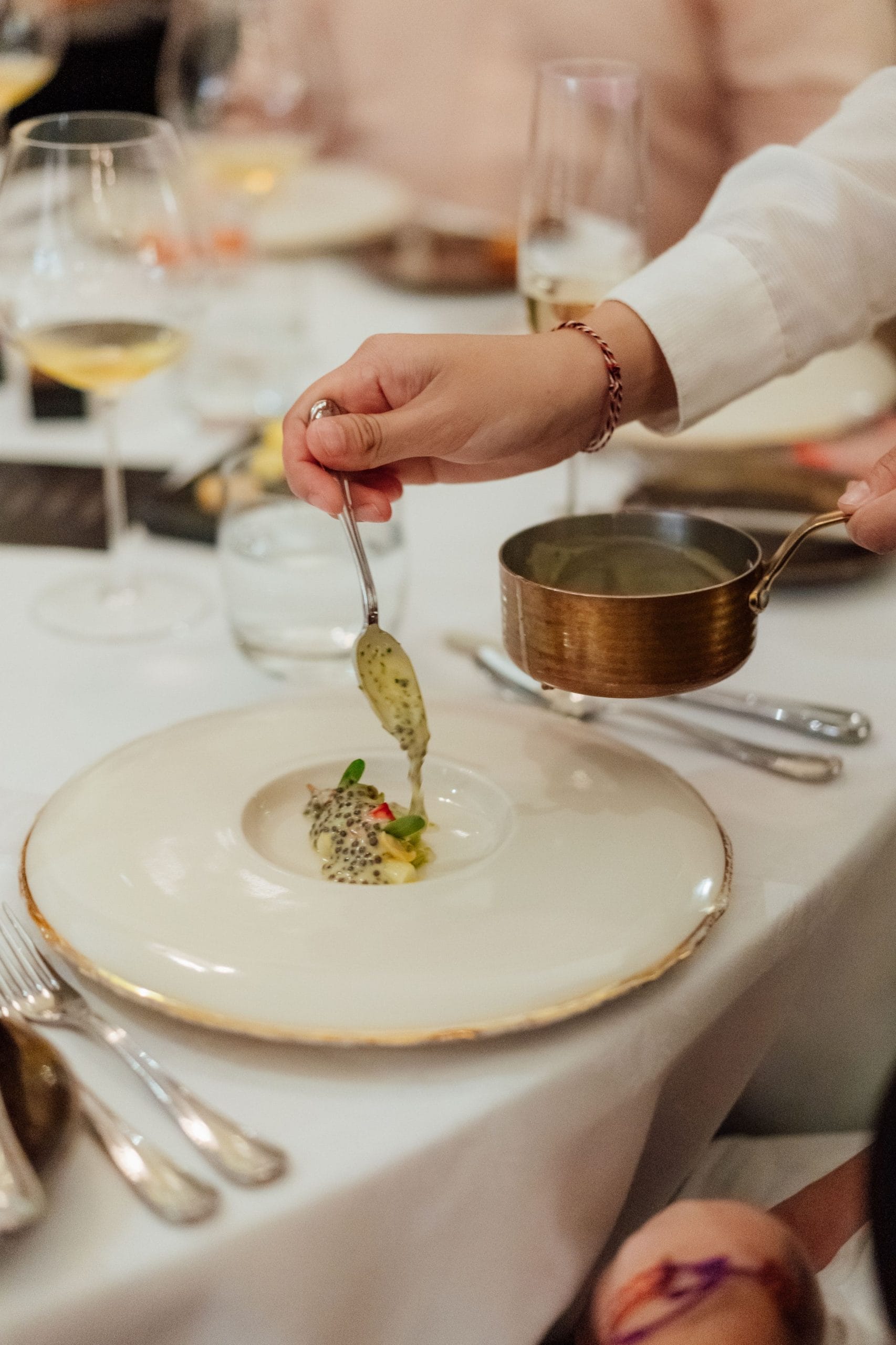 A Bali personal chef drizzling the final touches to a meal