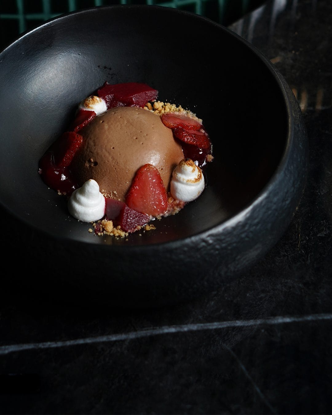 A catered dessert dish of chocolate mousse and fresh strawberries