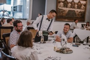 A wedding catering Bali team serving guests sparkling wine.